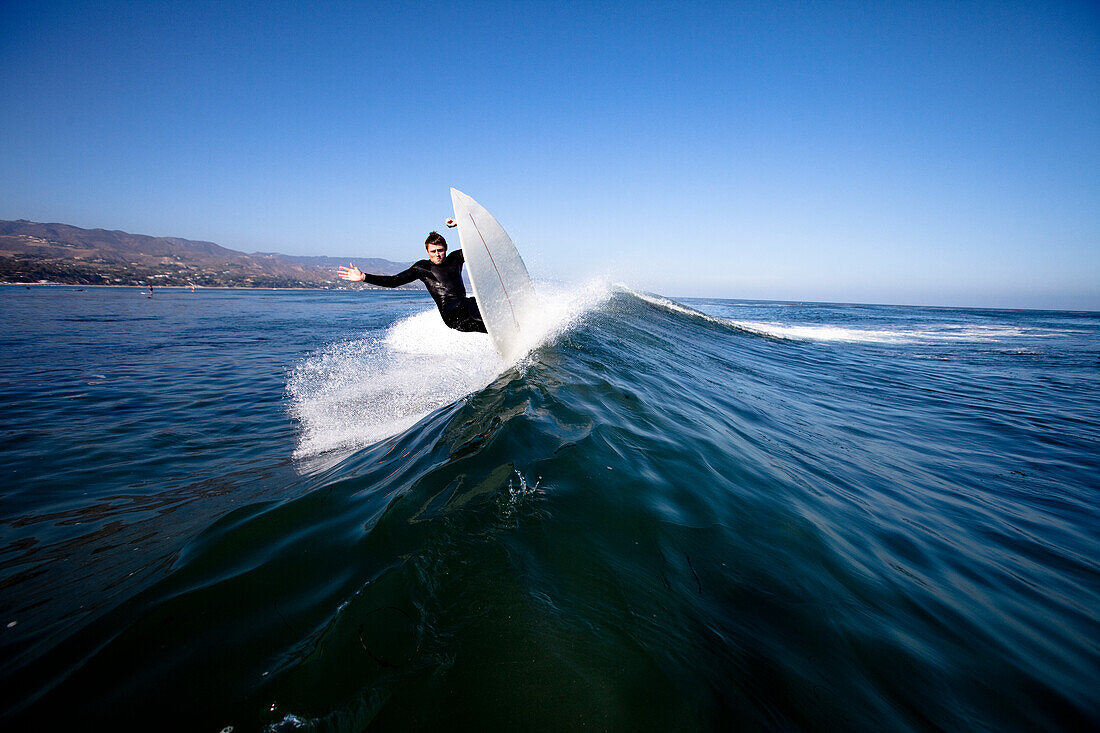 A young male surfer rips a top turn Malibu, California, United States of America