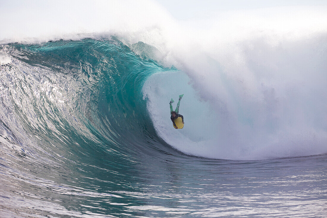 A man bodyboarding a huge wave at Shipsterns Bluff, Tasmania Tasman Peninsular, Tasmania, Australia