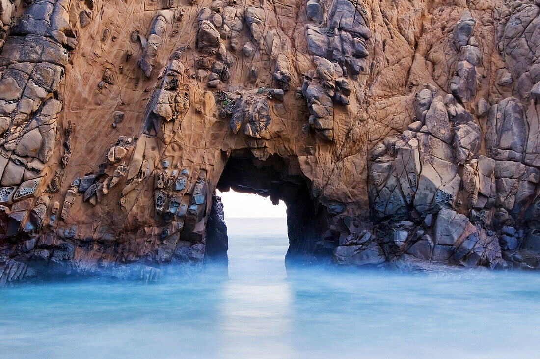 A sea arch at Pfeiffer Beach on the Big Sur coastline in California Big Sur, California, USA