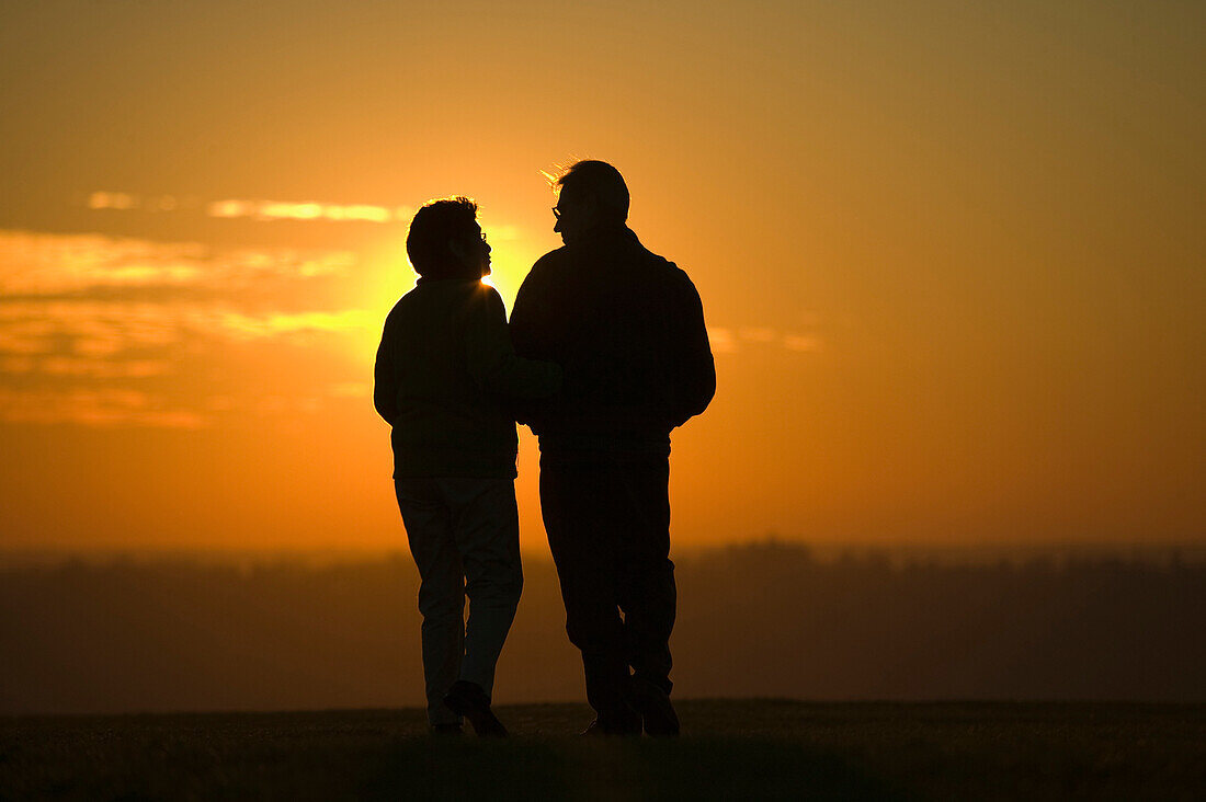 Hispanic couple standing outdoors at sunset, Seattle, WA
