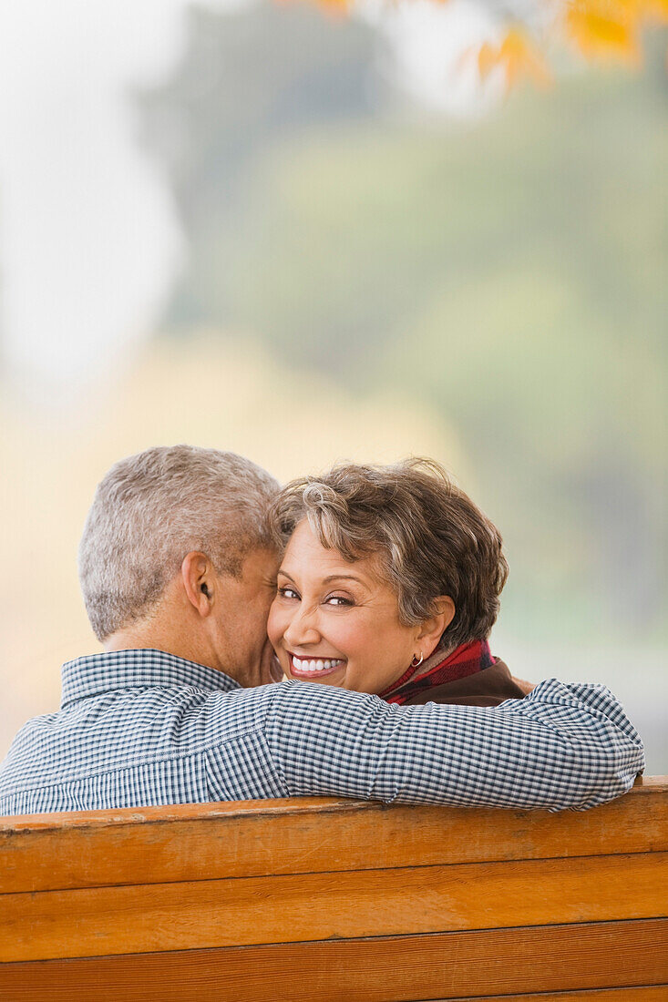 African couple hugging on park bench, Seattle, WA