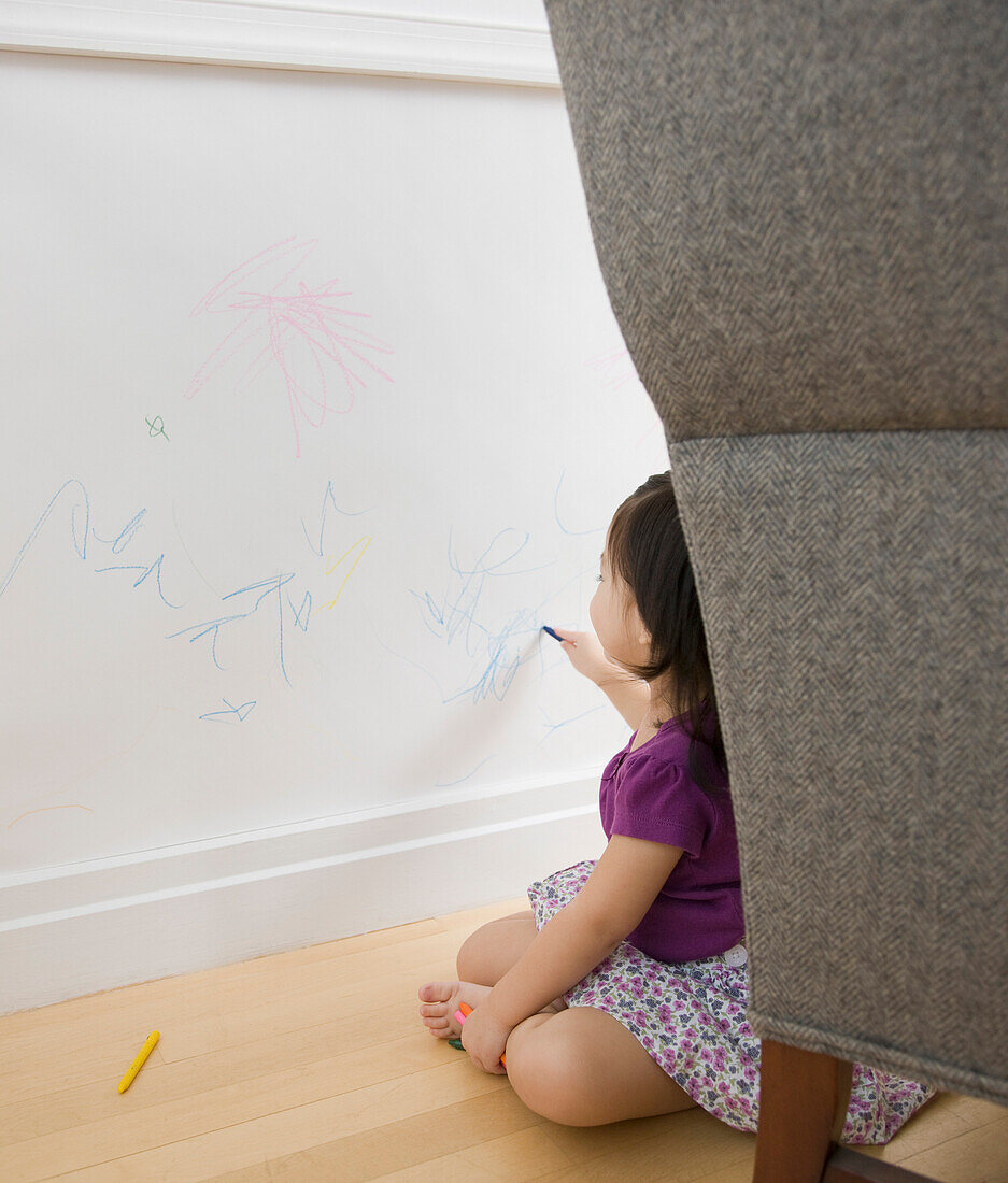 Toddler girl drawing on wall with crayons, Jersey City, NJ