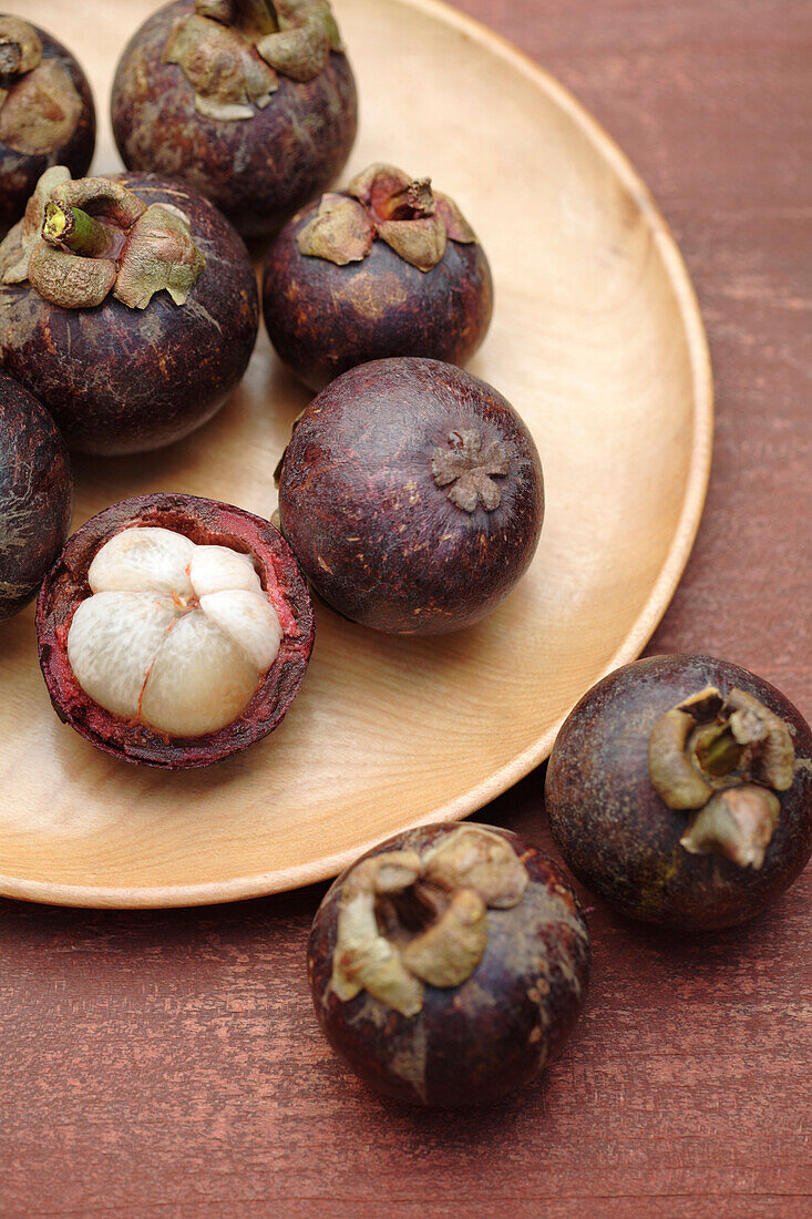 Mangosteen on wooden dish, Santa Fe, New Mexico, United States