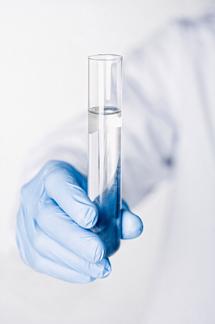 Hispanic scientist holding test tube full of water, Miami, Florida, United States