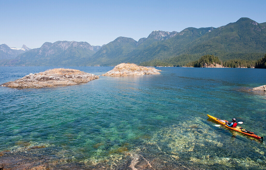 Hispanic woman kayaking on lake, Lund, British Columbia, Canada