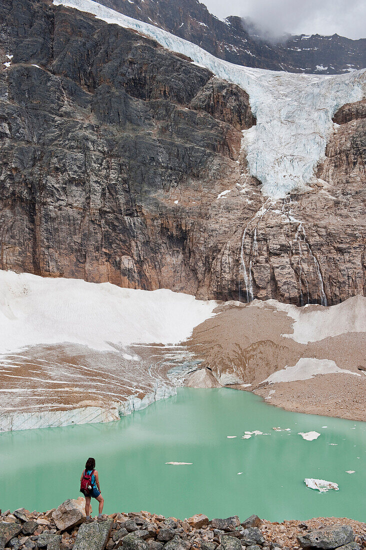 Hispanic woman hiking hear glacial lake, Jasper, Alberta, Canada