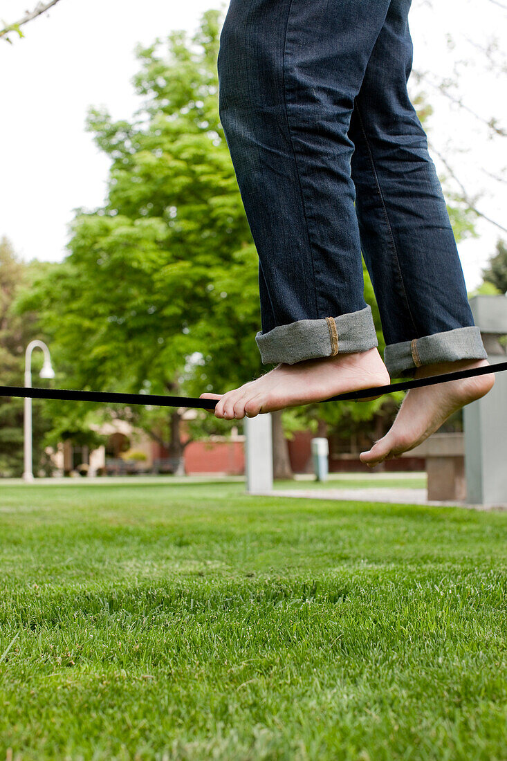 Caucasian man balancing on rope in park, Caldwell, Idaho, USA