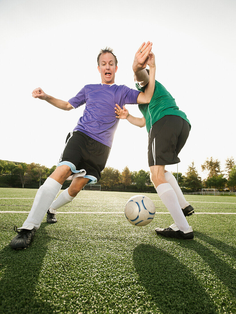 Men playing soccer on soccer field, Ladera Ranch, California, USA