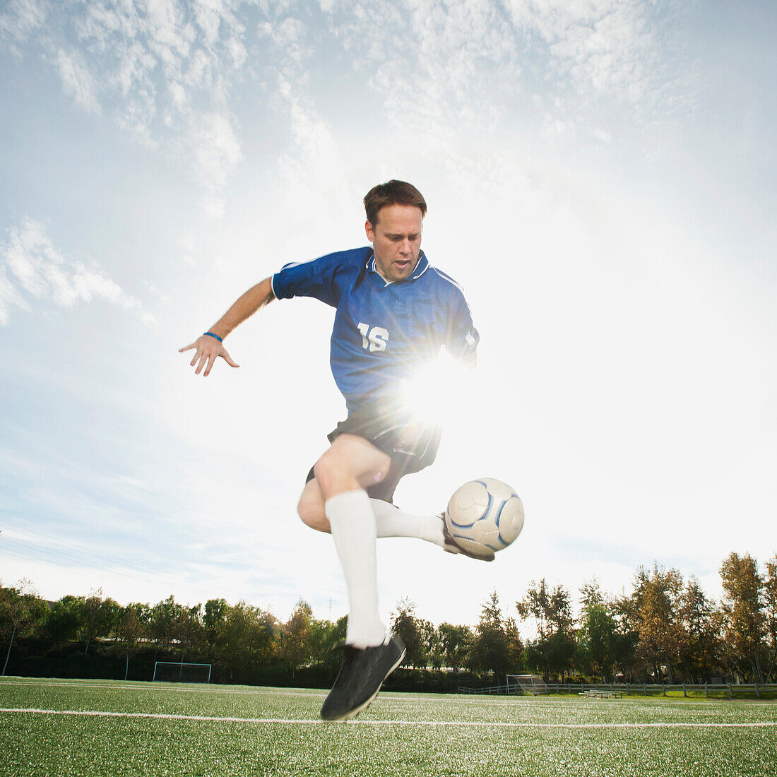 Caucasian soccer player kicking soccer ball, Ladera Ranch, California, USA