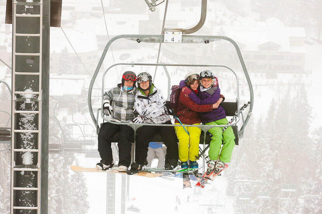 Friends riding ski lift, Taos, New Mexico, USA