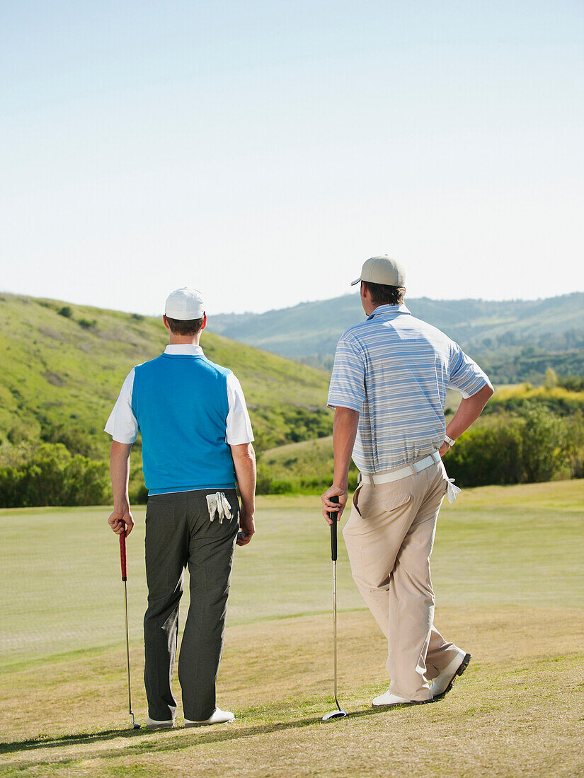 Caucasian men playing golf together on golf course, Mission Viejo, California, USA