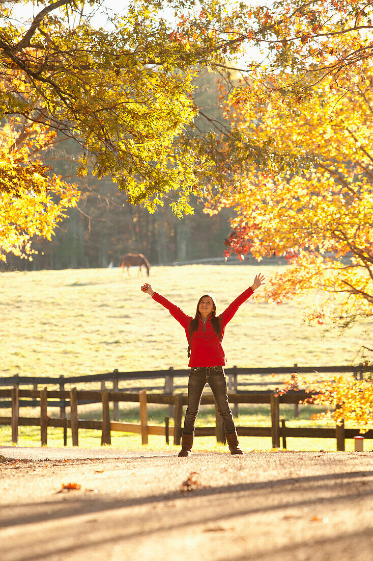 Caucasian girl standing with arms outstretched in countryside, Manakin, Virginia, USA
