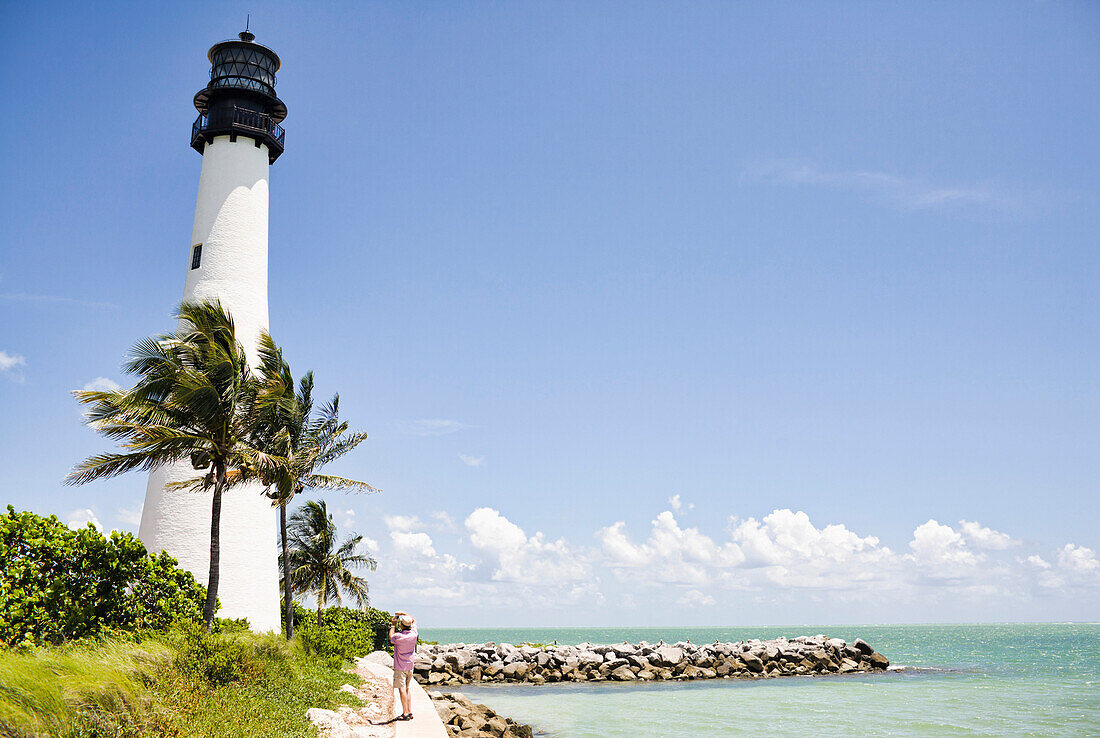 Lighthouse and tropical palm trees near ocean, Key Biscayne, Florida, United States