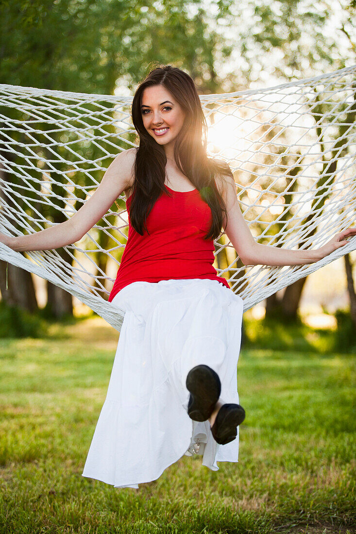 Caucasian woman sitting in hammock, Lehi, Utah, United States