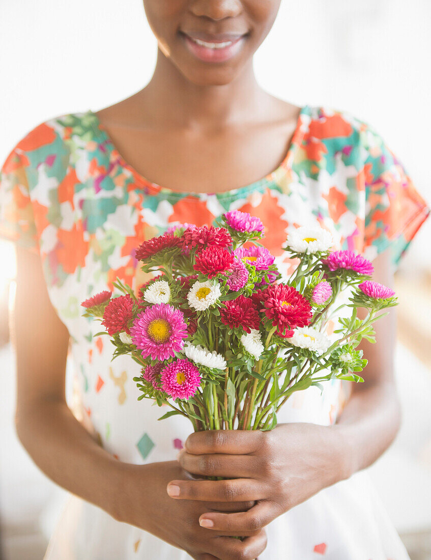 Woman holding bouquet of flowers, Jersey City, New Jersey, USA