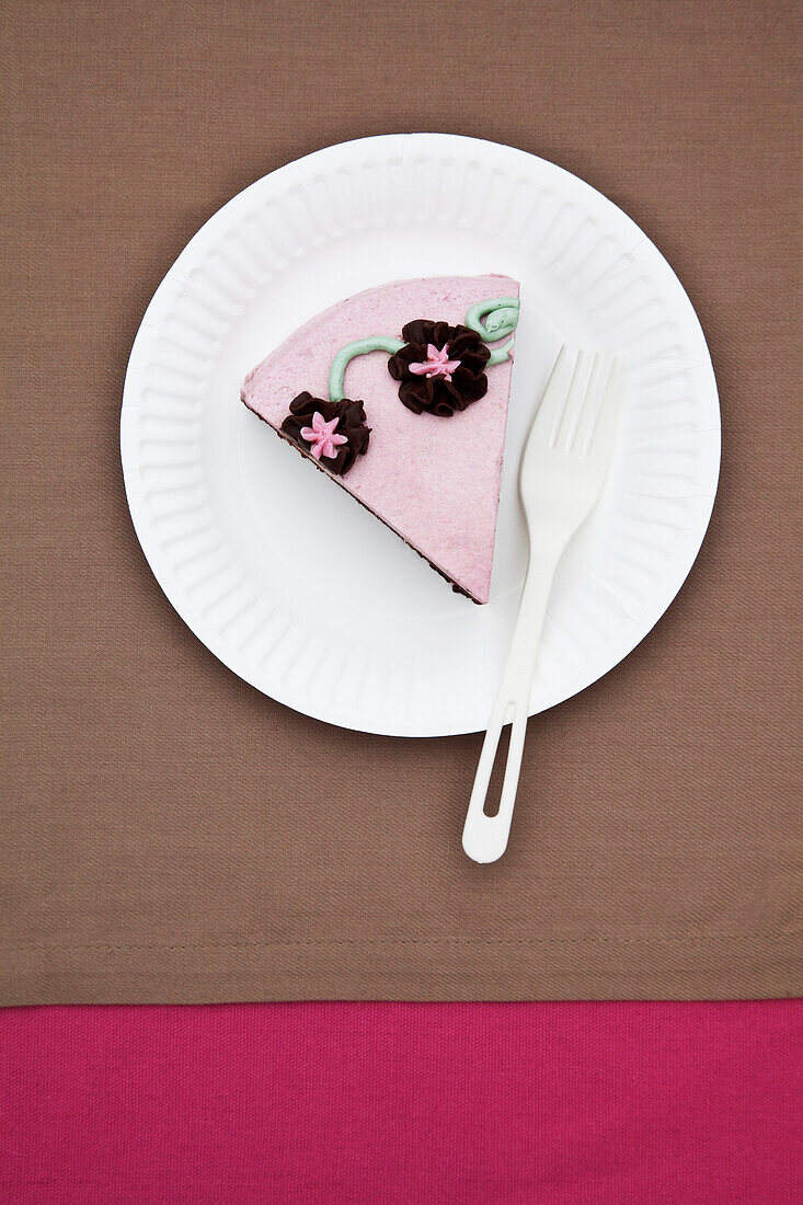 Slice of birthday cake on paper plate, San Francisco, CA, USA