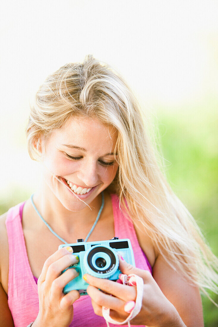 Caucasian woman holding camera, Heber, Utah, USA