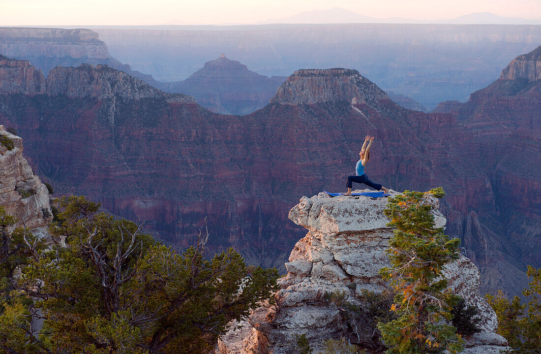 Caucasian woman practicing yoga on top of rock formation, Grand Canyon, Arizona, United States