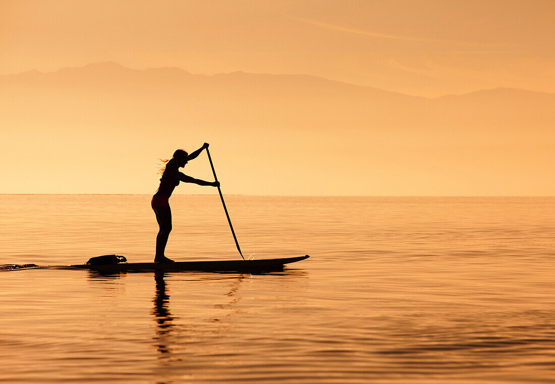 Caucasian woman standing on paddle board, Salt Lake City, Utah, USA