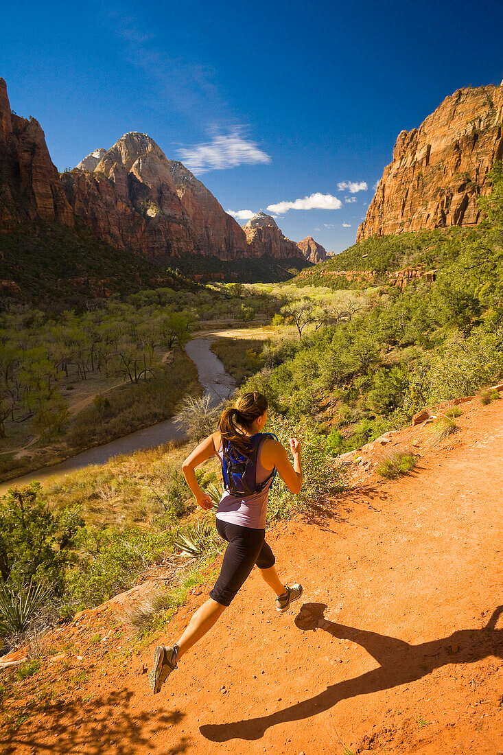 Persian woman running in canyon, Zion National Park, Utah, USA