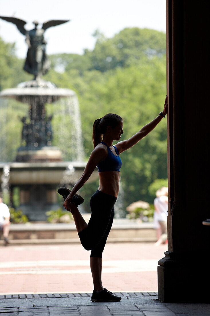 Kaukasische Frau dehnt sich vor dem Sport im Park, New York City, New York, USA