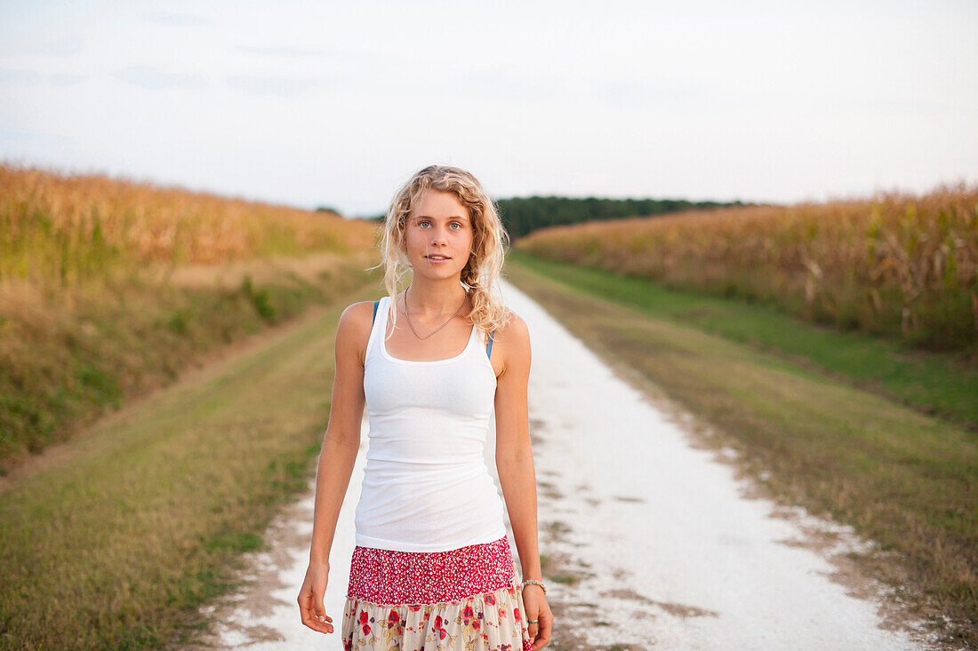 Caucasian woman standing on dirt road, Cape Charles, VA, USA