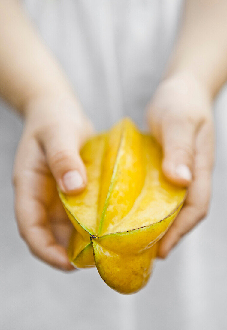 Caucasian child holding fruit, HANALEI, HAWAII, USA