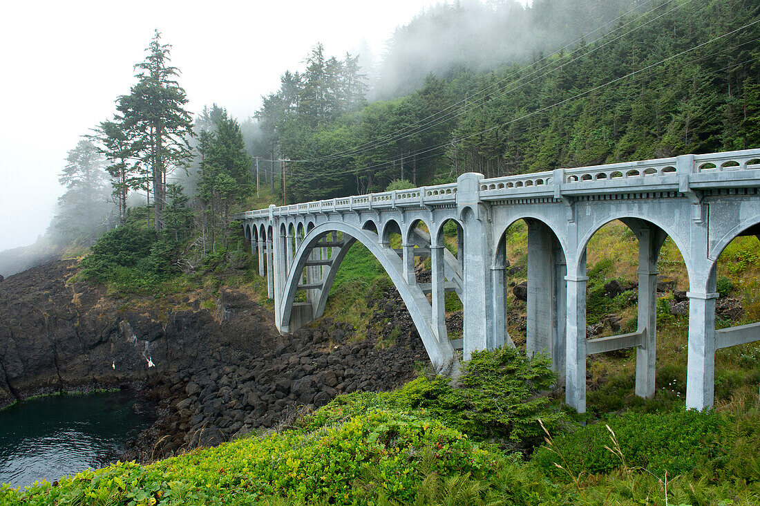 Bridge stretching over rocky valley, Newport, Oregon, USA