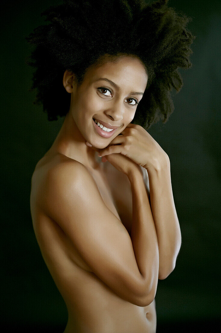 Nude mixed race woman covering her body, Los Angeles, California, USA