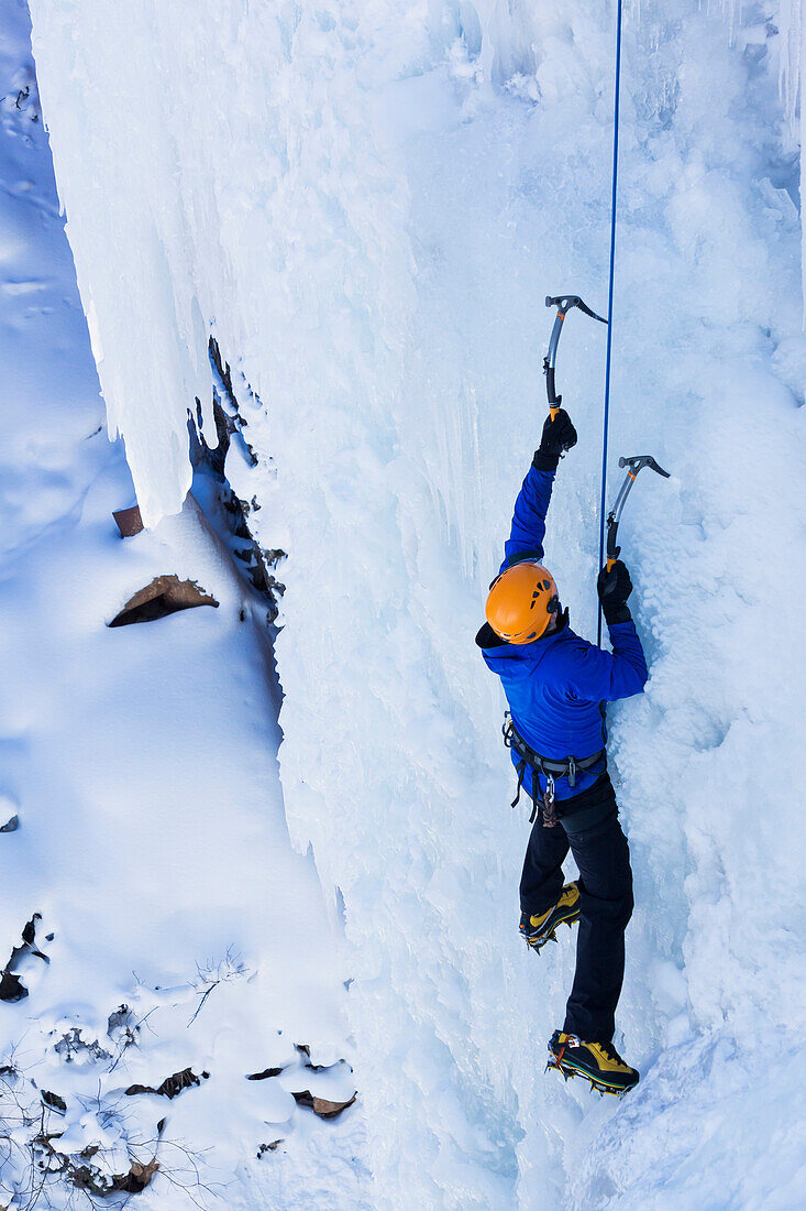 Caucasian climber scaling glacier, Ouray, CO, USA