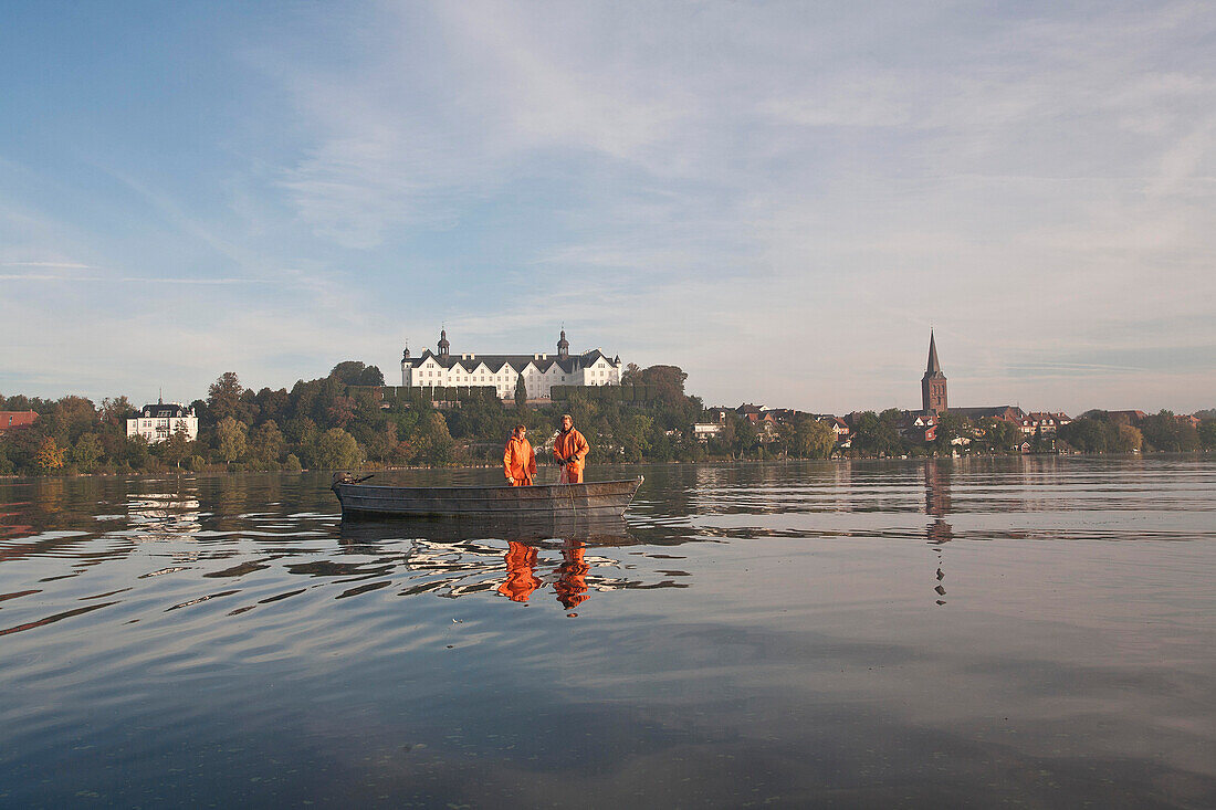 Inland fishermen, Lake Ploen and Ploen castle in the morning light, Ploen, Schleswig-Holstein, Germany