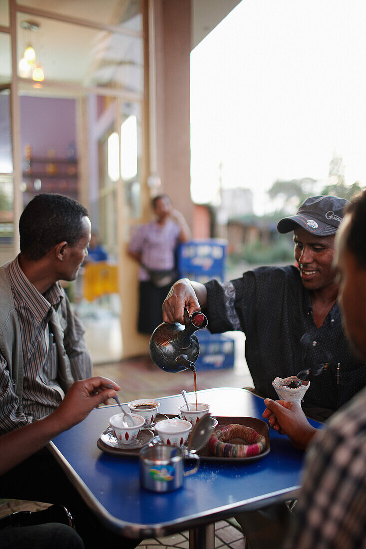 Men drinking Buna (coffee) in a pavement cafe, Bahir Dar, Amhara region, Ethiopia