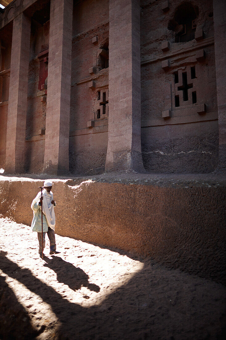 Visitor near monolithic church Bete Medhane Alem, Church of St. George, Lalibela, Amhara region, Ethiopia