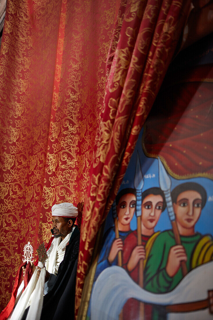 Priest holding Lalibela cross, Church of Saint George, Lalibela, Amhara region, Ethiopia