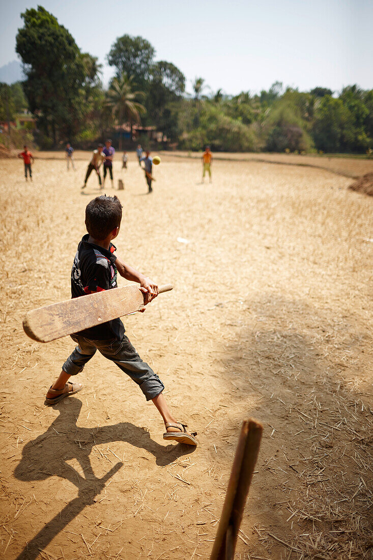 Boys playing cricket, Kakkinje, Karnataka, India