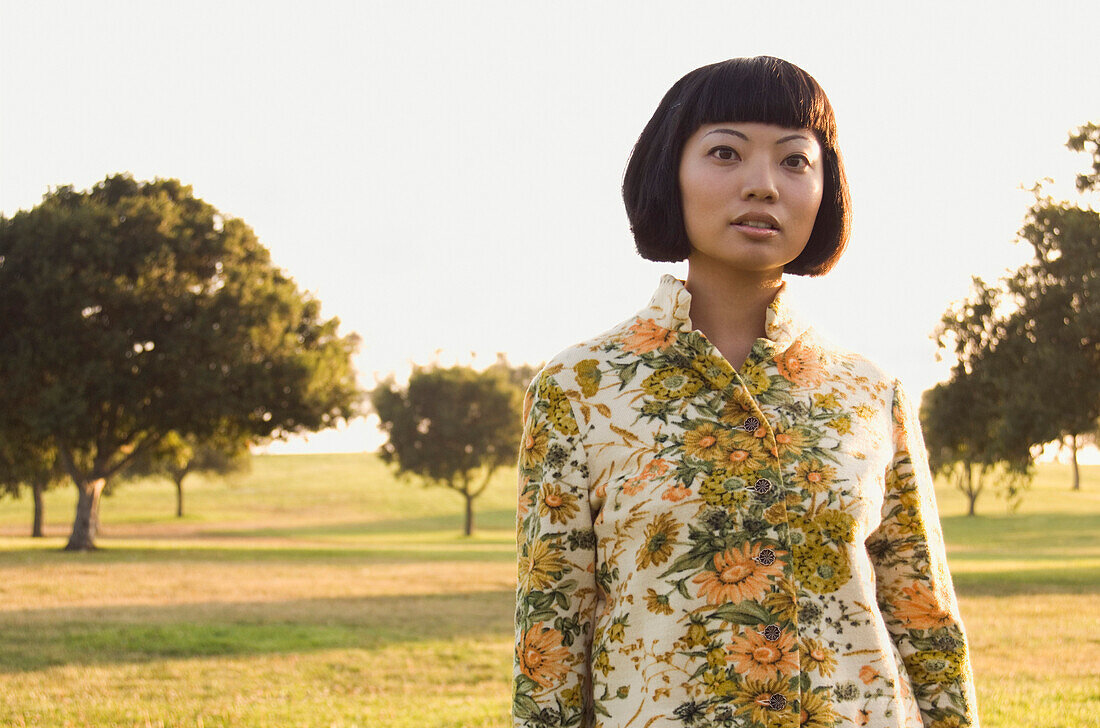 Portrait of Asian woman in meadow, Kenneth Hahn State Park, CA