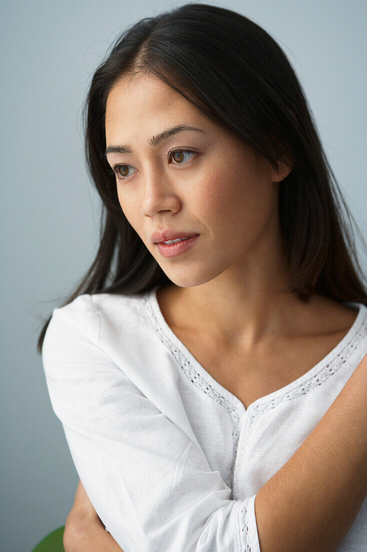 Asian woman holding arm across chest, Gaithersburg, MD
