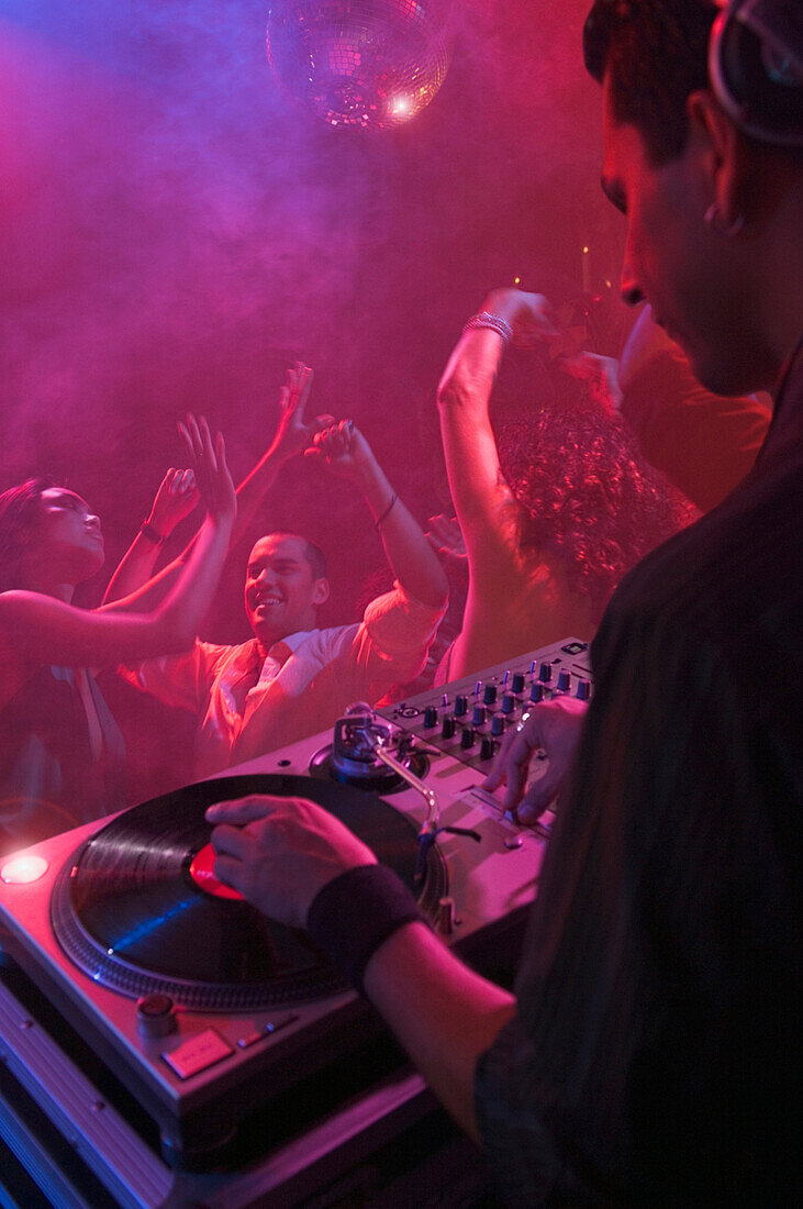 Hispanic dj playing at nightclub, Los Angeles, CA