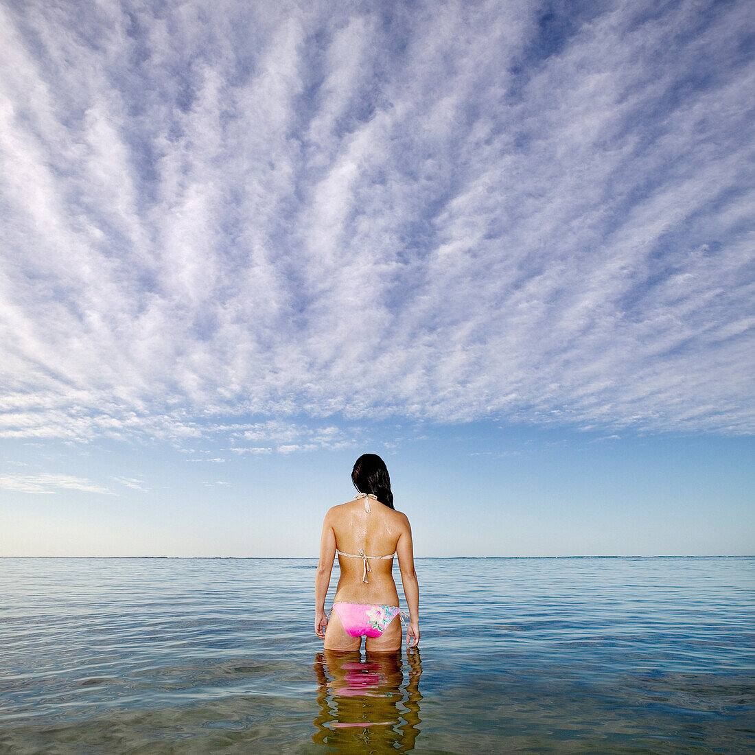 Pacific Islander woman standing in ocean, Hawaii