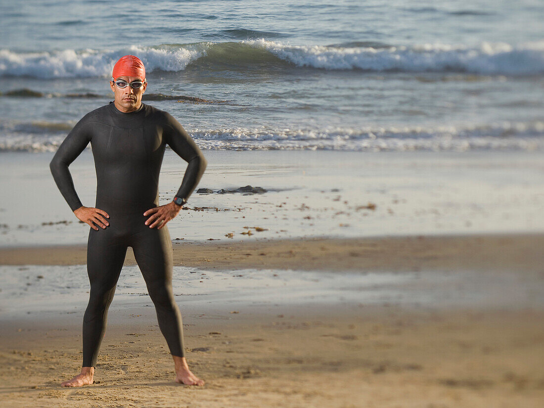 Hispanic man wearing wetsuit and goggles, Newport Beach, CA