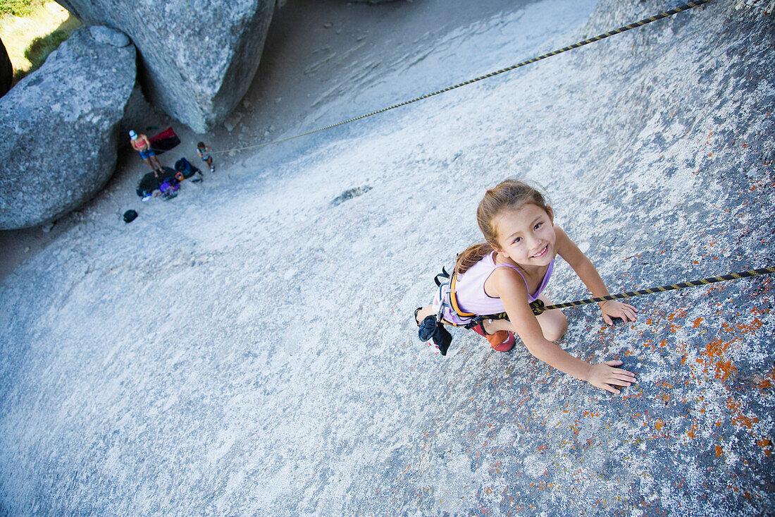 Asian girl rock climbing, City of Rocks State Park, ID