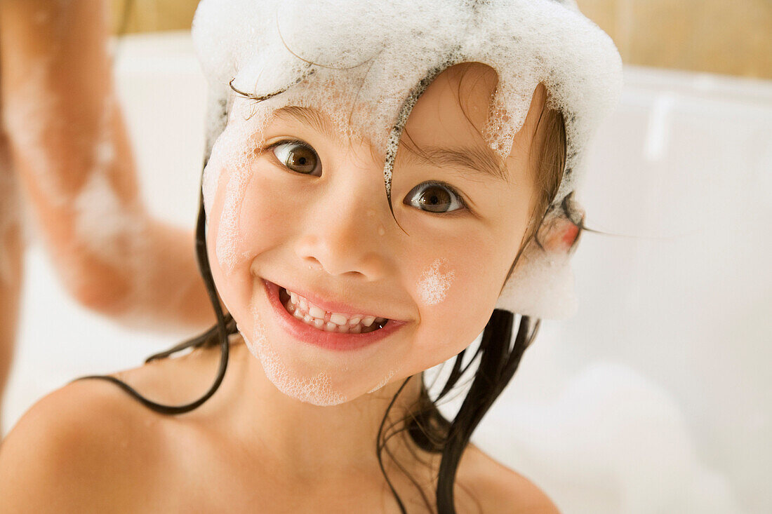 Asian girl in bubble bath, Seattle, WA