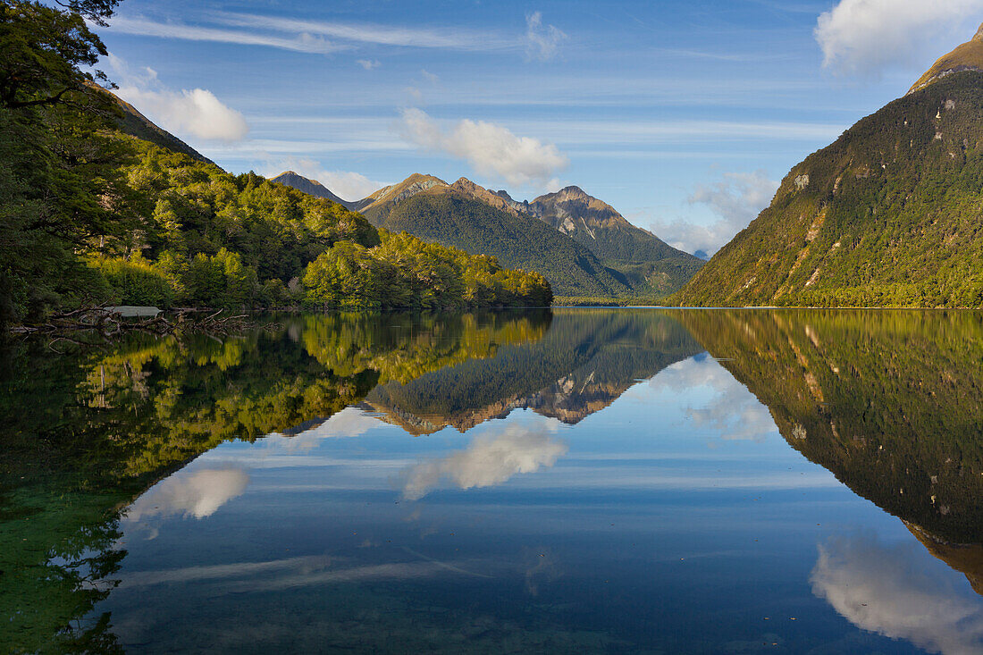 Reflection of the mountains in Lake Gunn, Fiordland National park, Southland, South Island, New Zealand