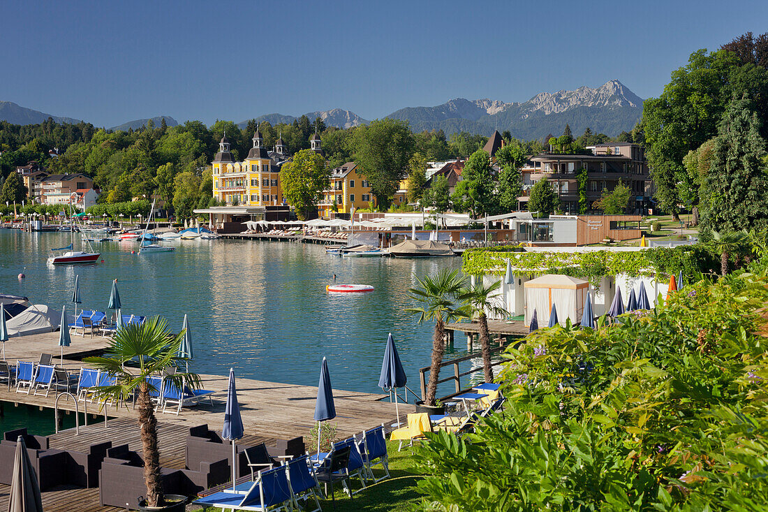 Velden castle with sun loungers and platform, Lake Woerthersee, Carinthia, Austria