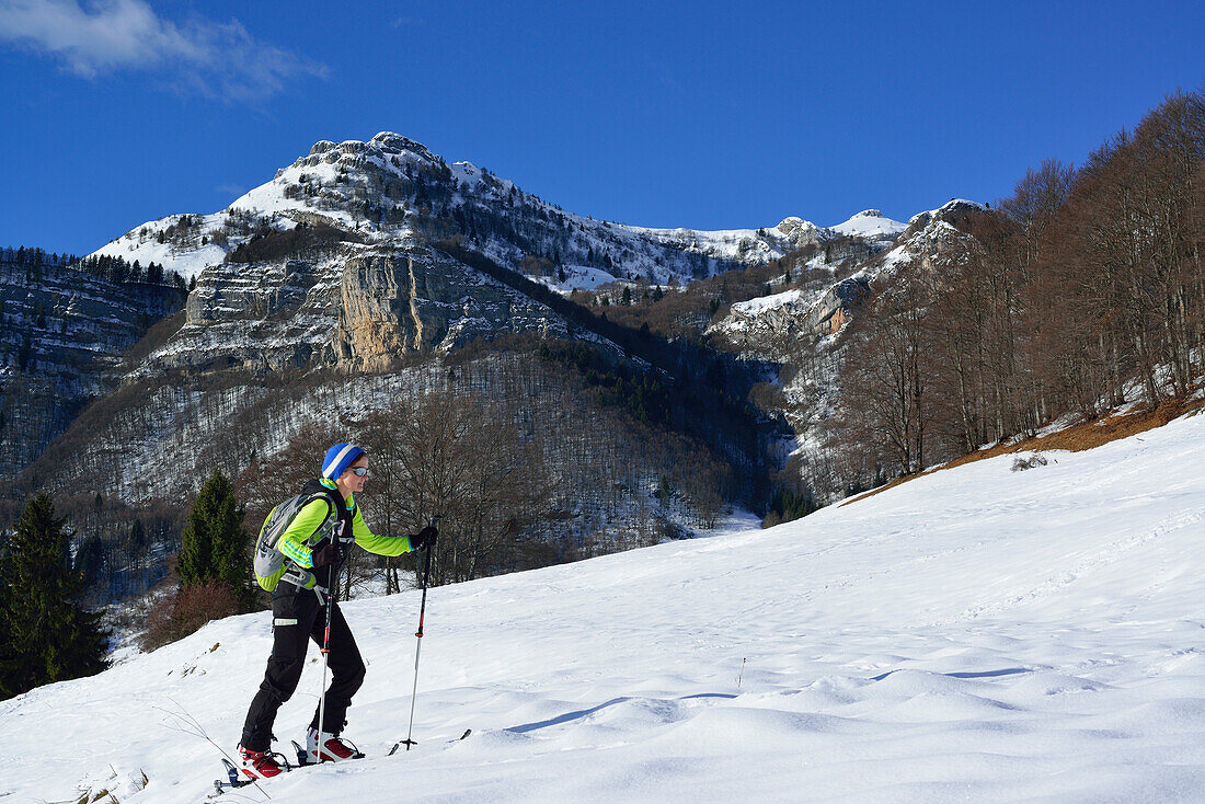 Female back-country skier ascending to Monte Baldo, Garda Mountains, Trentino, Italy