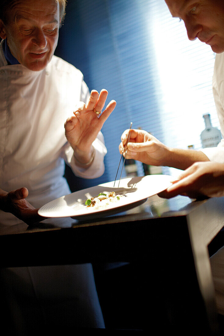 Chefs preparing marinated scallops with Enoki mushrooms, Angelik pearls and pomelos in a gourmet restaurant, Baerenthal, Moselle, Lorraine, France
