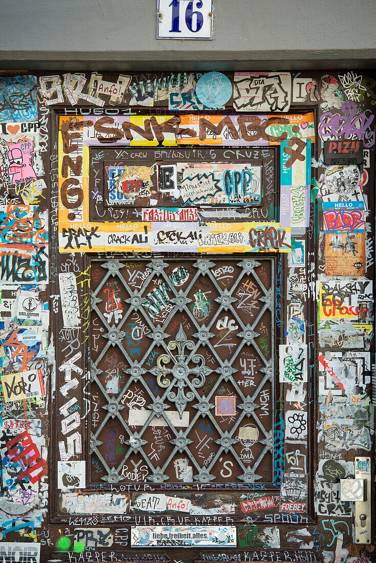 Door plastered with graffiti and stickers, historic center, Freiburg im Breisgau, Black Forest, Baden-Wuerttemberg, Germany