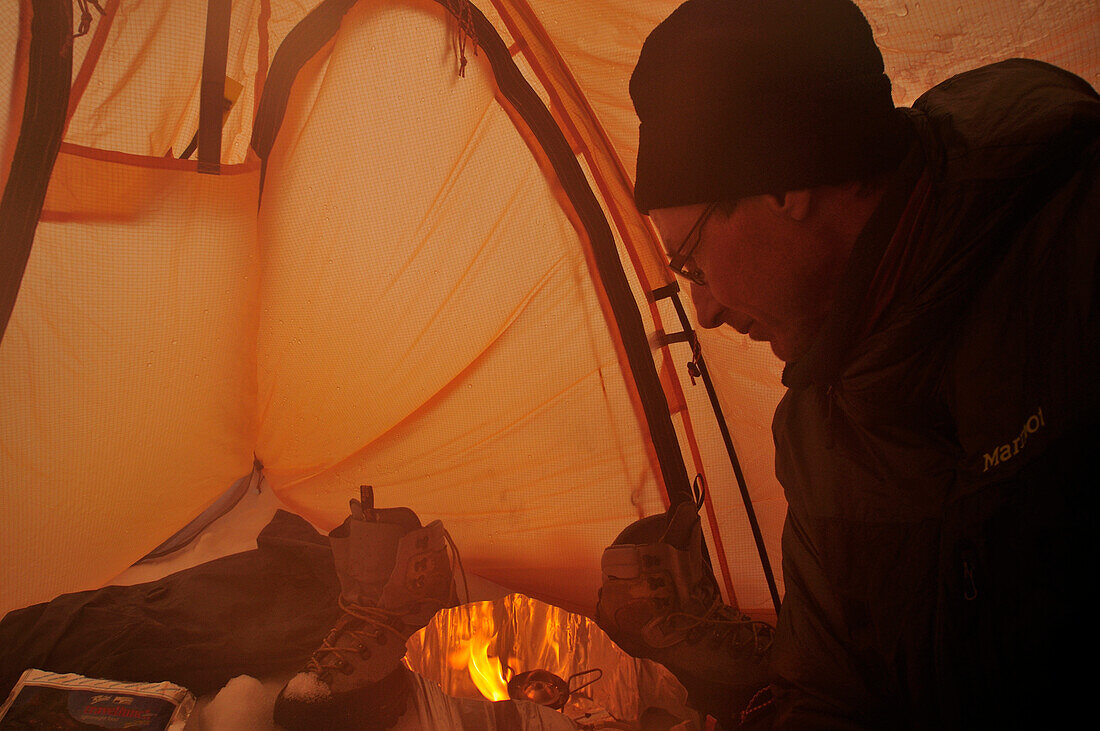 Cooking in a tent, base camp at Monte Sarmiento, Tierra del Fuego, Chile