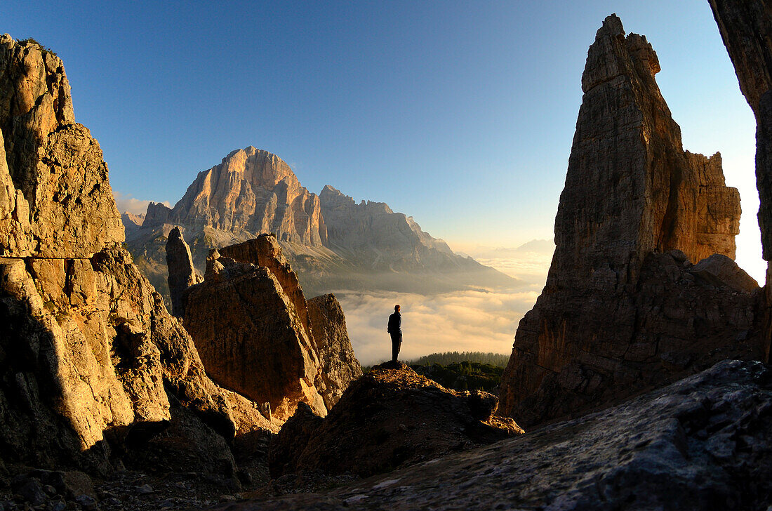 Man in sunrise, Tofana di Rozes in background, Cinque Torri, Dolomites, Vento, Italy