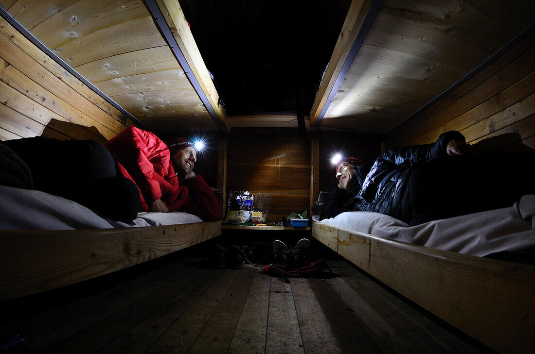 Two climbers overnighting in wilderness hut bivacco Ettore Castiglioni, Crozzon di Brenta, Brenta Dolomites, Trentino, Italia
